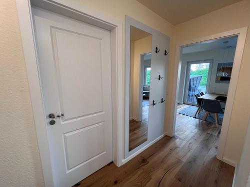 an empty room with a door and a hallway at Ferienwohnung-Frees-Mooi in Neßmersiel