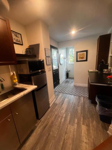 a kitchen with wooden floors and a large room at Sunset Suites in Niagara Wine Country in Niagara on the Lake