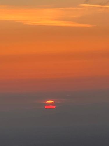 a sun setting in the middle of the ocean at Bergwelt Kandel Hotel & Eventlocation in Waldkirch