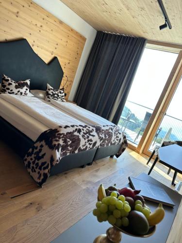 a bedroom with a bed and a table with a bowl of fruit at Bergwelt Kandel Hotel & Eventlocation in Waldkirch