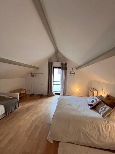 a bedroom with a large white bed and a window at Le Sevirqueno in Bougarber