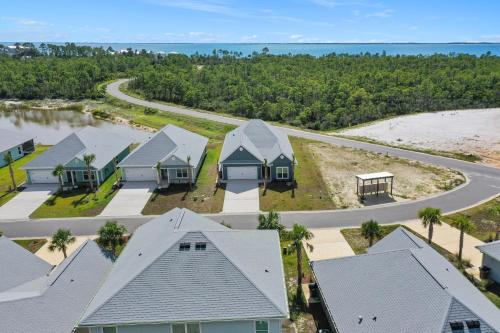 an aerial view of a row of houses on the beach at Backwater Bliss by Pristine Properties Vacation Rentals in Saint Joe Beach