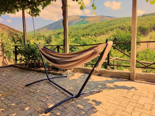 a hammock with a view of a mountain at Casa da Latada in Coentral das Barreiras