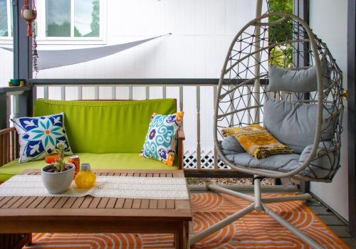a porch with a swing and a table and a chair at Stylish, Artsy Bungalow Central Eastside in Austin