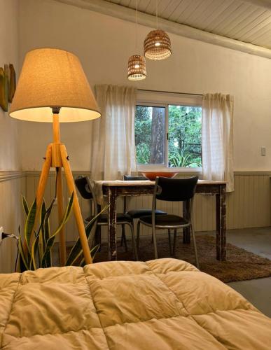a bedroom with a table and a lamp and a bed at La casita de CristAl in Puerto Rico
