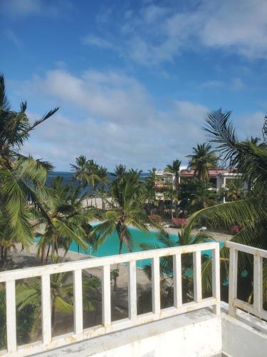 a view of the beach from the balcony of a resort at Muna Beachfront Apartment in Malindi