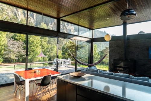 a living room with a table and a large window at Casa Satori in Suesca