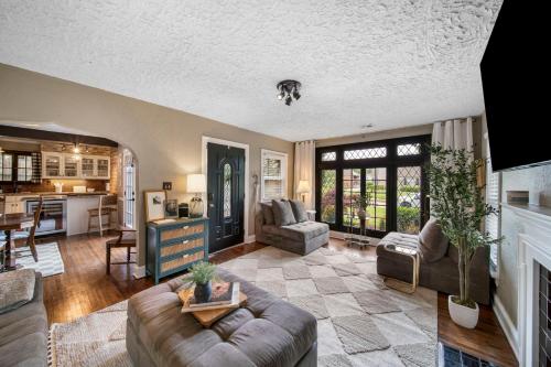 a large living room with a couch and a table at Ivy Cottage w hot tub by HVNLYhomes in Tulsa