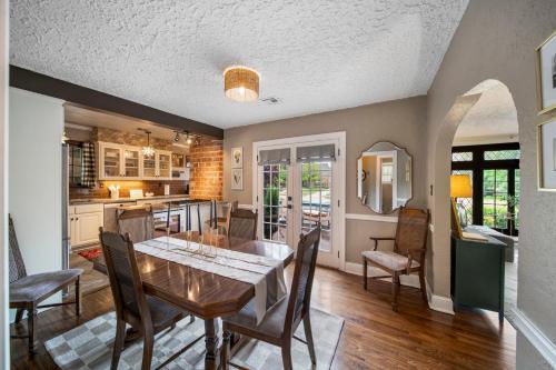 a kitchen and dining room with a table and chairs at Ivy Cottage w hot tub by HVNLYhomes in Tulsa