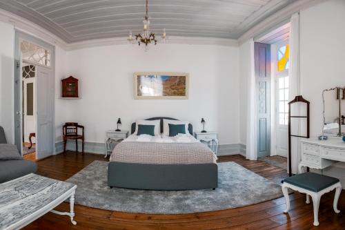 a bedroom with a bed and a chandelier at Manteigas Lovers in Manteigas
