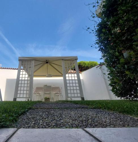 a white gazebo with a table and umbrella at MINZONI94 - TwoBedroom+Garden in Lido di Camaiore