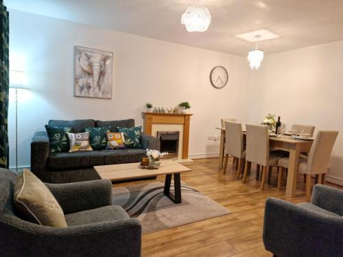 a living room with a couch and a table at Delight Marvel-Waltham Place - Ashford in Ashford