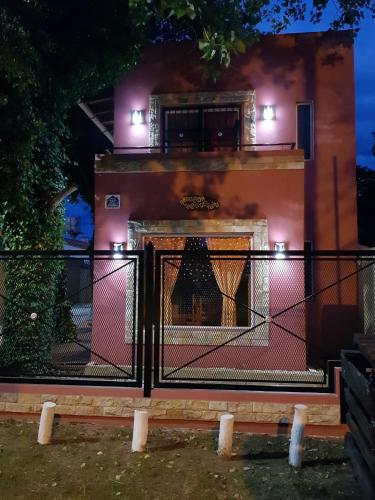 a building with a gate in front of it at night at Arbolada Talas del Tuyu in San Clemente del Tuyú