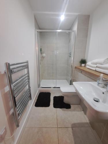 a bathroom with a shower and a sink at Media City Apartment Manchester in Manchester