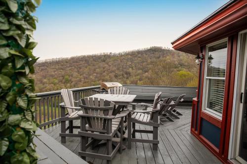 a table and chairs on the deck of a house at Devil's Lookout in Seven Devils