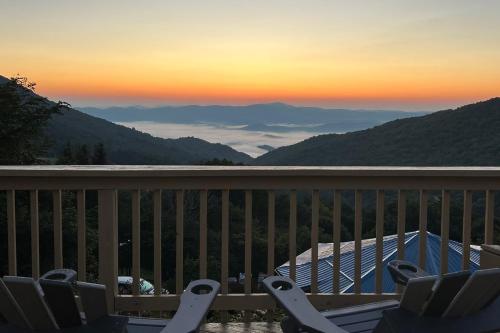 a deck with chairs and a view of the mountains at Devil's Lookout in Seven Devils