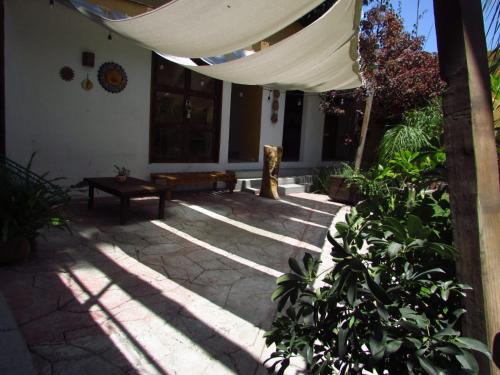 a patio with a canopy and a bench in a house at Hotel San Ángel en Atlixco in Atlixco