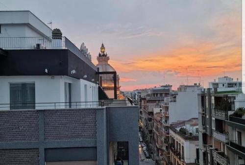 a view of a city at sunset from a building at Attico Reale - in Centro, tra Stazione e Bari Vecchia in Bari
