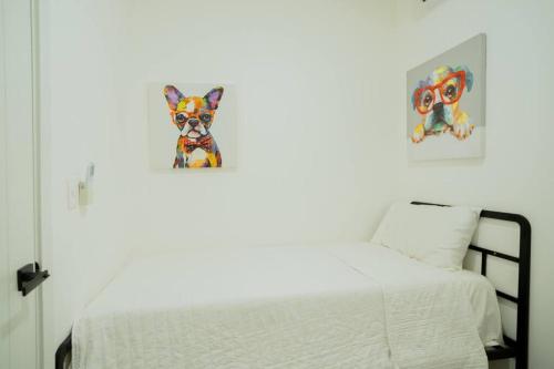 a bedroom with a bed and a picture of a dog at Luxury Retreat Condo 3BR Pool & Spa Azzure-Cap Cana in Punta Cana