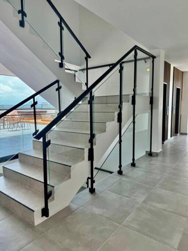 a staircase in a house with a view of the ocean at Luxury Retreat Condo 3BR Pool & Spa Azzure-Cap Cana in Punta Cana