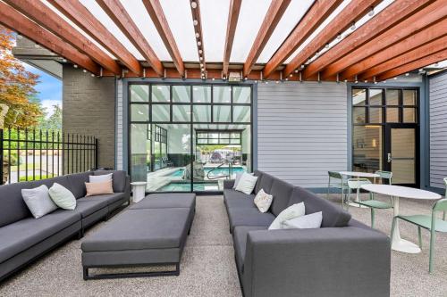 an outdoor patio with couches and a table with a table at Best Western Plus Puyallup Hotel in Puyallup
