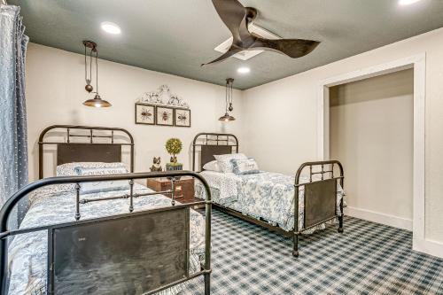 a bedroom with two beds and a ceiling fan at Benton Harbor Home 3 Mi to Beach Grill and Yard in Benton Harbor