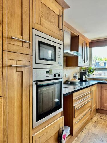 a kitchen with two microwaves on the wall at Two bedroom maisonette in the heart of the West End in Glasgow
