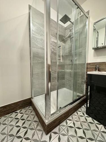 a glass shower in a bathroom with a sink at Two bedroom maisonette in the heart of the West End in Glasgow