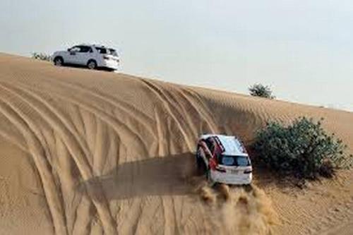 a car parked in the middle of a desert at Aaladdin luxury camp in Merzouga