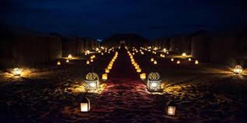 a row of lights on a street at night at Aaladdin luxury camp in Merzouga