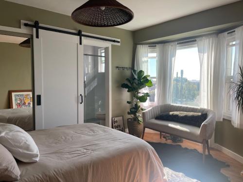 a bedroom with a bed and a chair and a window at Inglewood Forum and Sofi park and walk private room in Inglewood