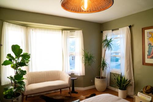 a living room with a chair and two windows at Inglewood Forum and Sofi park and walk private room in Inglewood