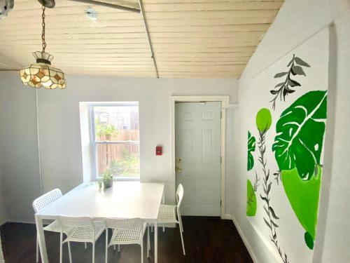 a dining room with a white table and chairs at Legacy - Spring Garden University City in Philadelphia
