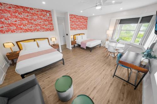 a hotel room with a bed and a desk at Greenview Hotel By Lowkl in Miami Beach