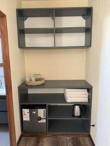 a shelf in the corner of a room at Florida 55 in Salta