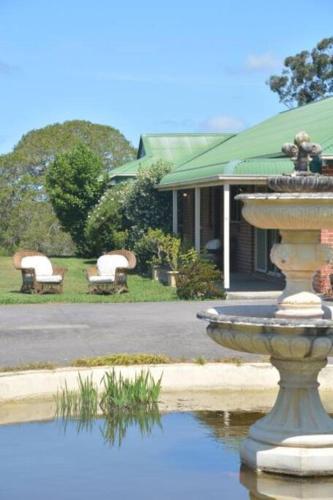 a water fountain in front of a house at Charlie & Roy's Farm Berry in Berry