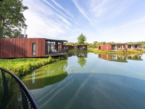 a house on the side of a river at Nature Escape Bungalow in Antoing