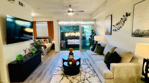 a living room with a couch and a table at Luxury Open BD w Pool, Parking, & WD 133 in Los Angeles