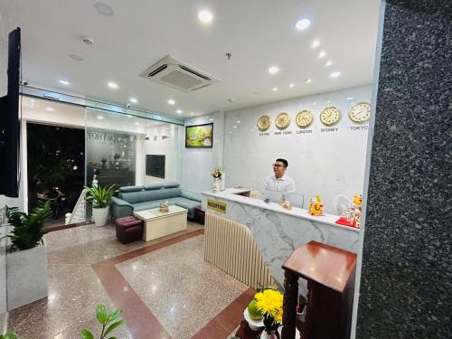 a man standing at a counter in a restaurant at HAVI hotel in Ho Chi Minh City
