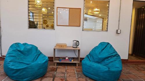 two blue bean bags sitting next to a wall at Tribu Coliving in Envigado