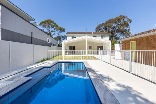 a swimming pool in the backyard of a house at Callala on King - Pet Friendly with Swimming Pool in Callala Beach
