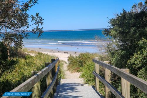 a path leading to a beach with the ocean at Callala on King - Pet Friendly with Swimming Pool in Callala Beach