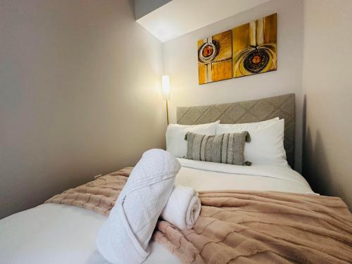 a bedroom with a bed with towels on it at RivetStays - The Jarvis in Toronto