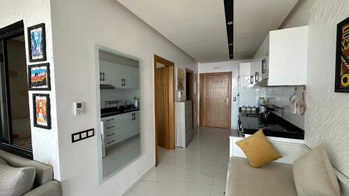a living room with a couch and a kitchen at Appartement a La Perle de La plage de Mehdia Kenitra vue sur mer Excellent sea view in Plage de Mehdia
