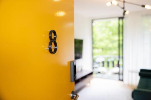 a door with the number eight on a yellow wall at Peppertree Apartments in Sale