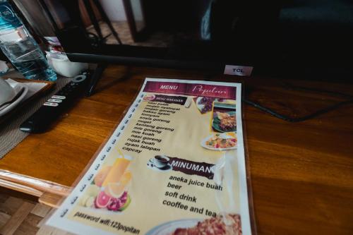 a menu on a table with some food on it at Popitan Garden Campground & Glamping Bedugul in Bedugul
