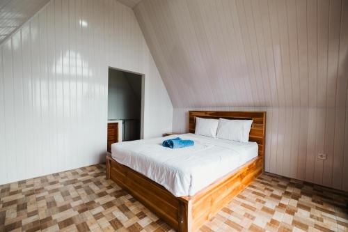 a bedroom with a large bed in a room at Popitan Garden Campground & Glamping Bedugul in Bedugul