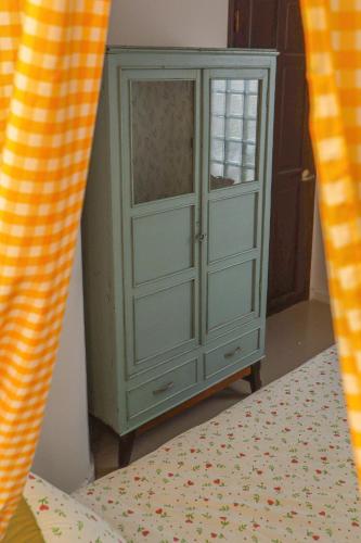 a green cabinet in a room with a bed at DƯỚI TÁN CÂY homestay in Tây Ninh