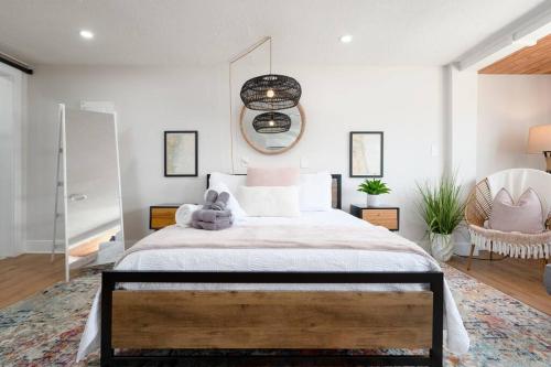 a bedroom with a large bed and a mirror at Be A Nomad - Beach Cottage Oceanfront in Jacksonville Beach
