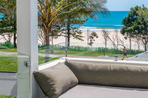 a couch in front of a window with a view of the beach at Lawson House 2 in Byron Bay
